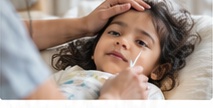 Paediatric doctor gently evaluating a child with fever
